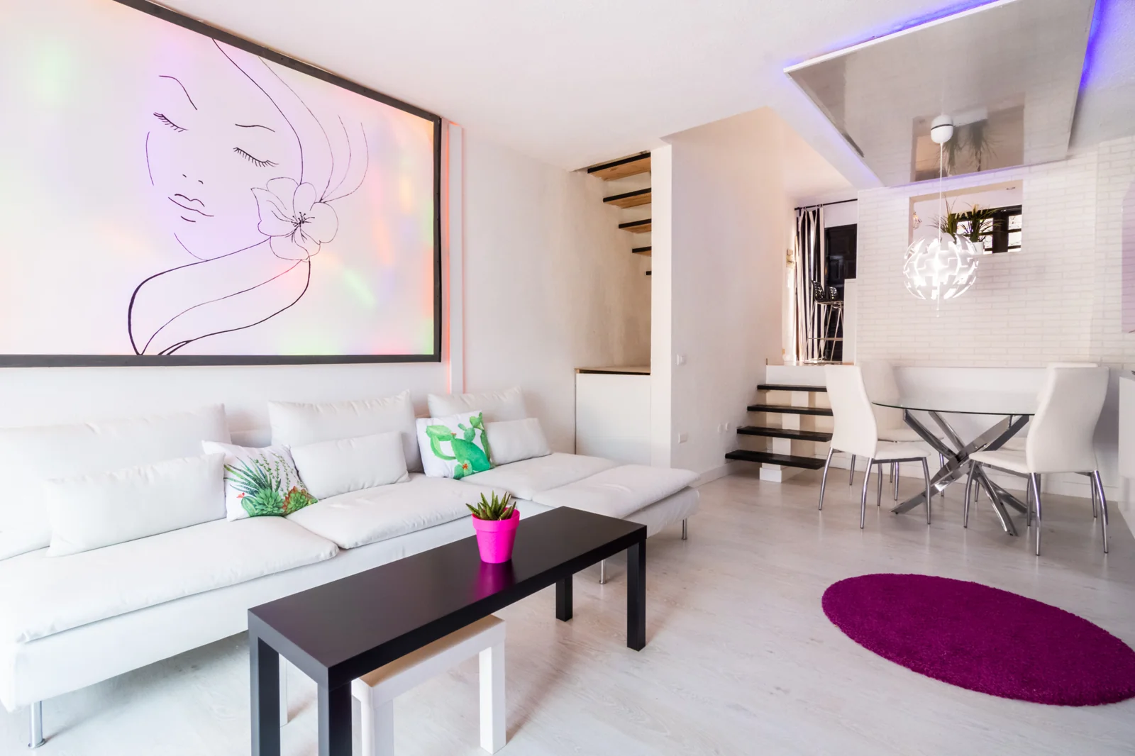 White living room opening onto a dining area.