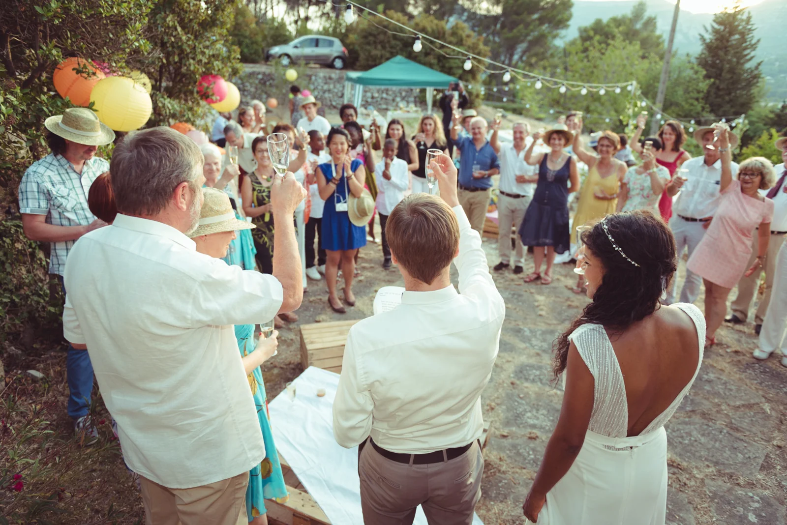 Wedding guests gathered outdoors for a celebration.