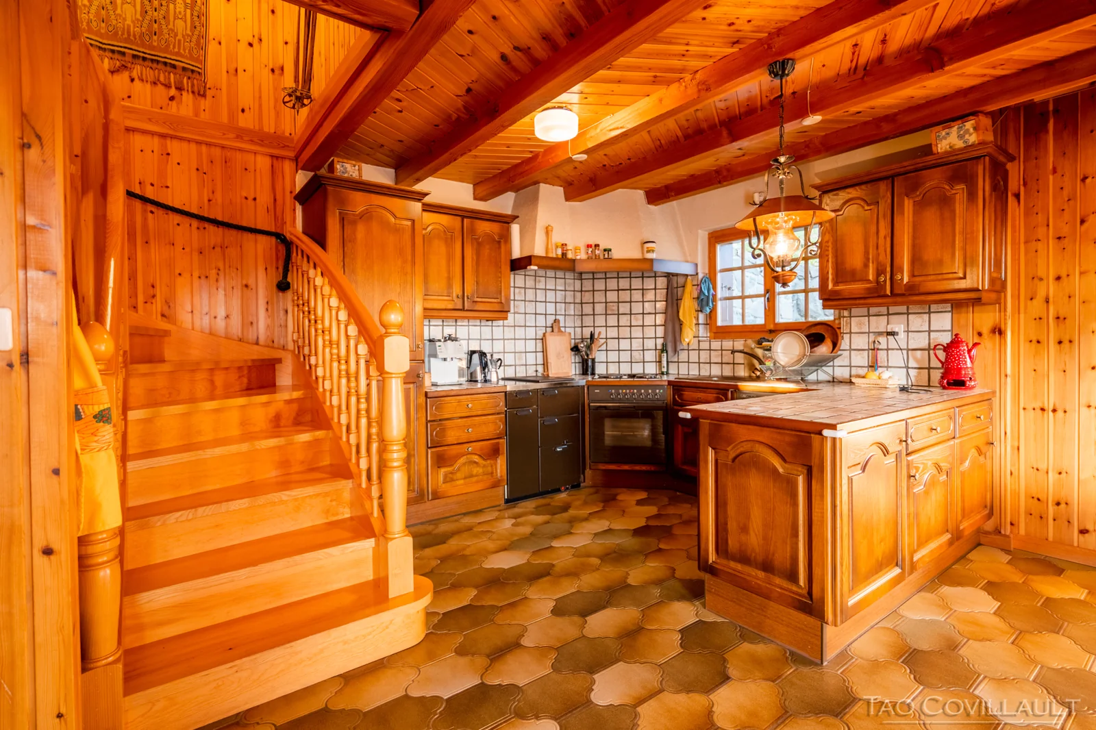 Rustic chalet kitchen with wooden cabinets.
