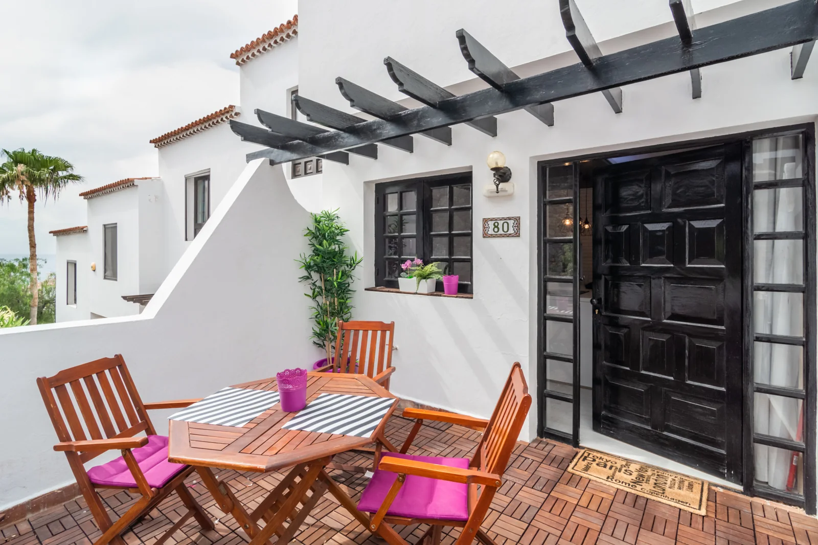 Outdoor dining terrace with a wooden table.
