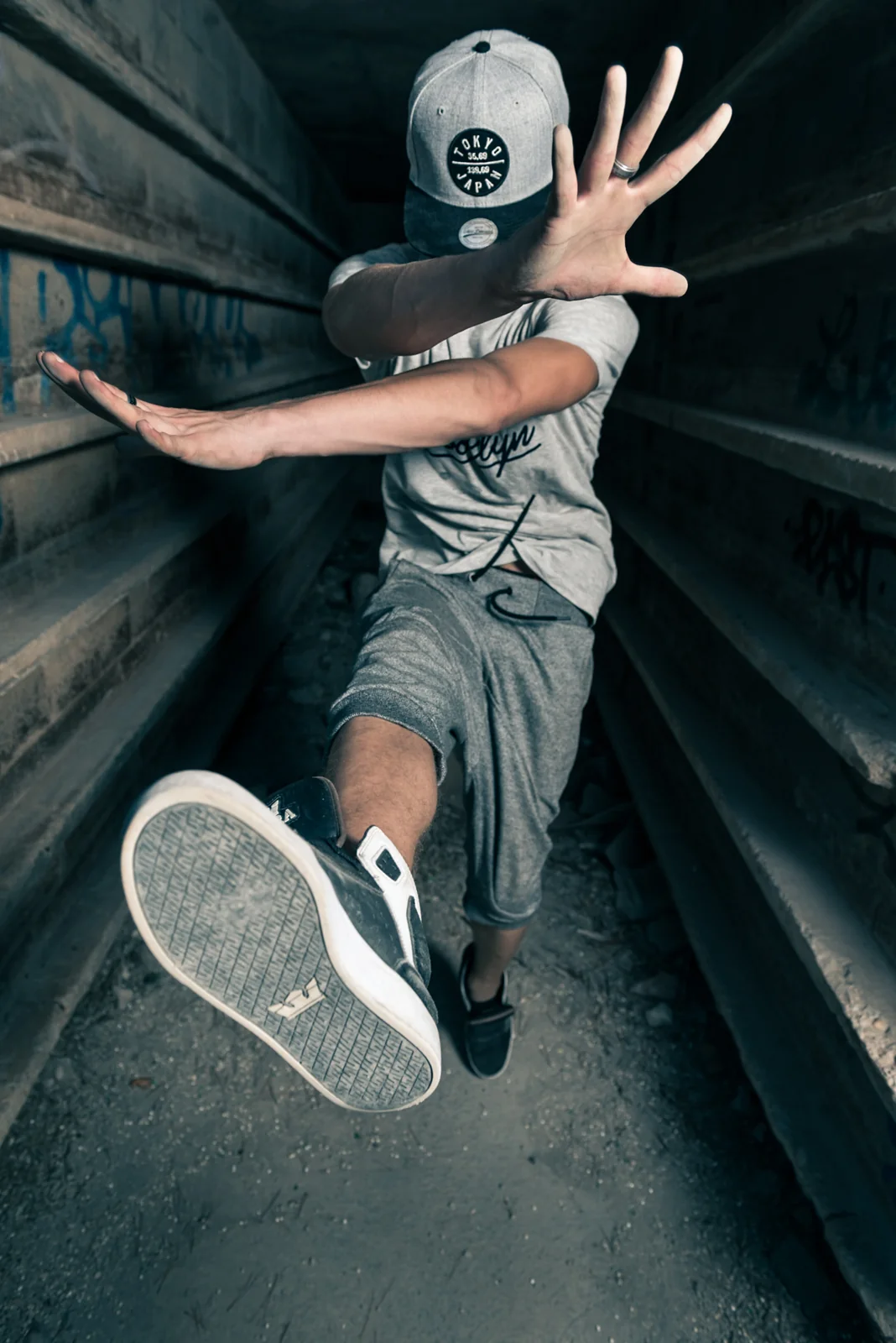 Street dancer extending a foot toward the camera.