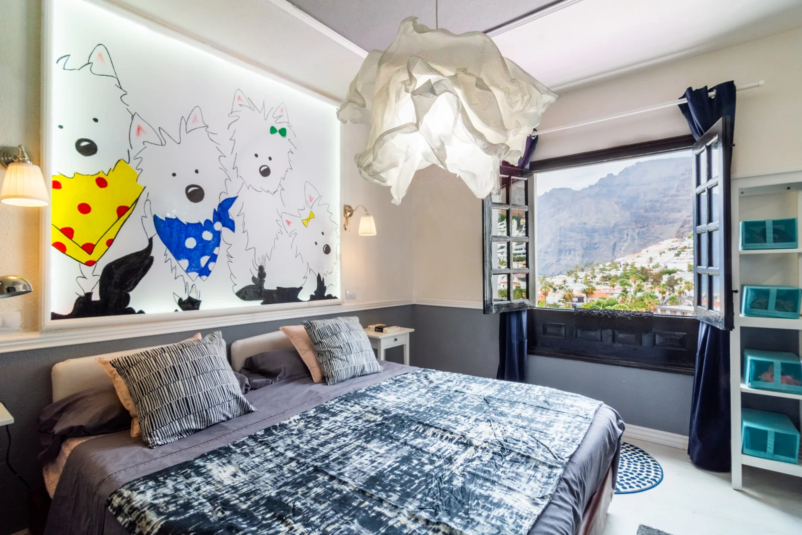 Bedroom with illustrated wall art and dark bedding.