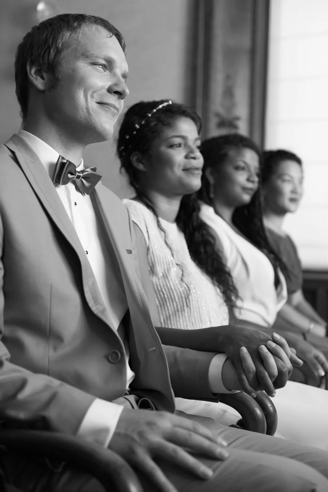 Black-and-white photograph of the couple seated during their ceremony.