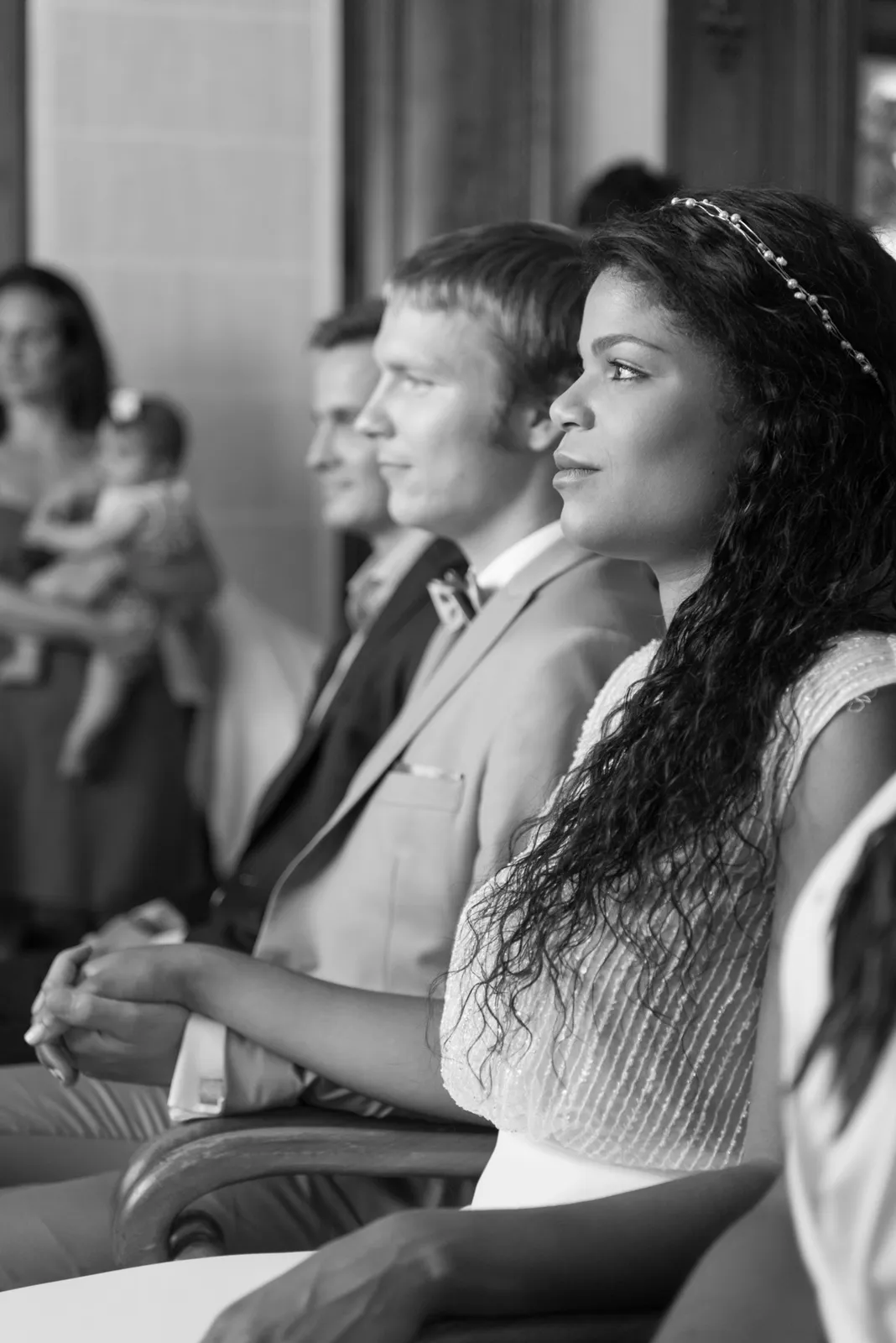 Bride listening during the wedding ceremony in black and white.