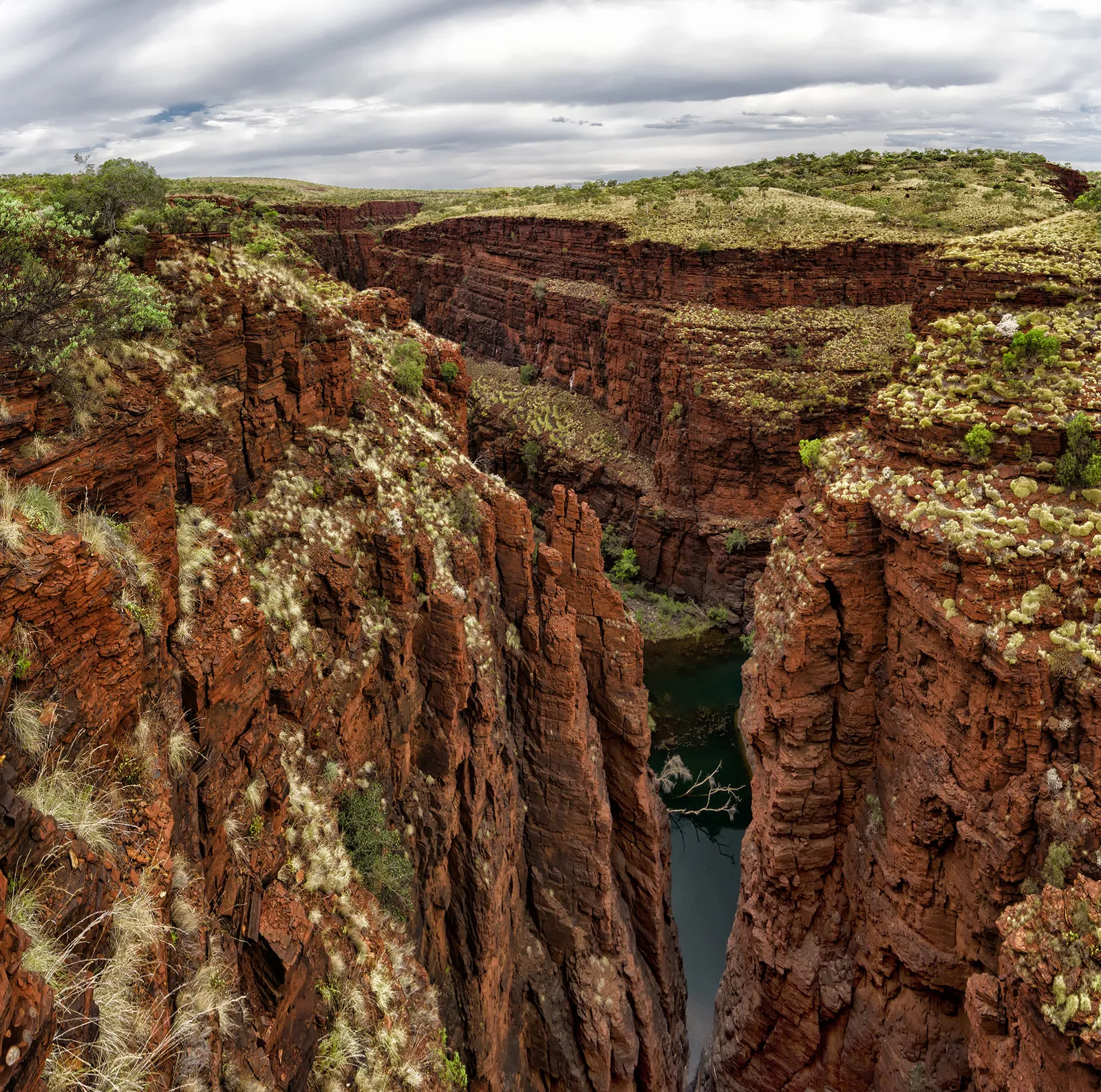 Narrow river between steep red canyon walls