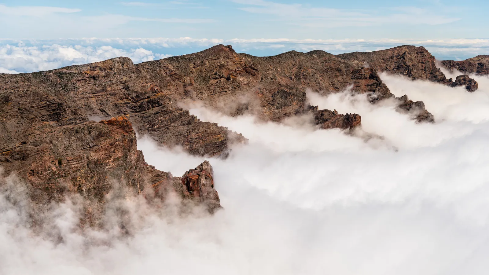 Rugged mountain peaks surrounded by low clouds