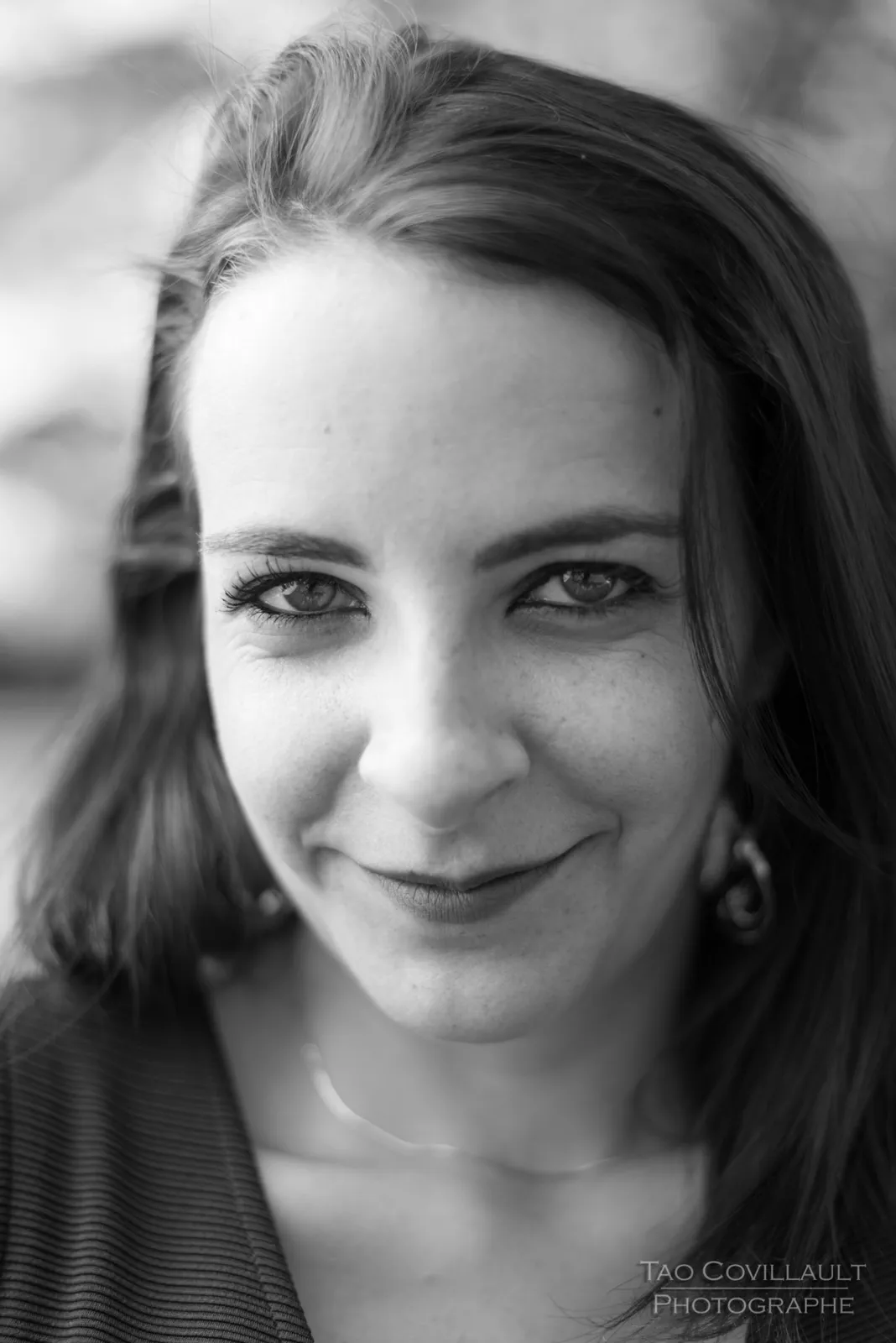 Black-and-white photograph: close-up portrait of a woman in a black dress.
