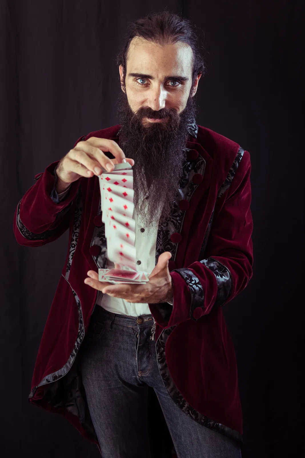 Bearded performer holding a transparent container.