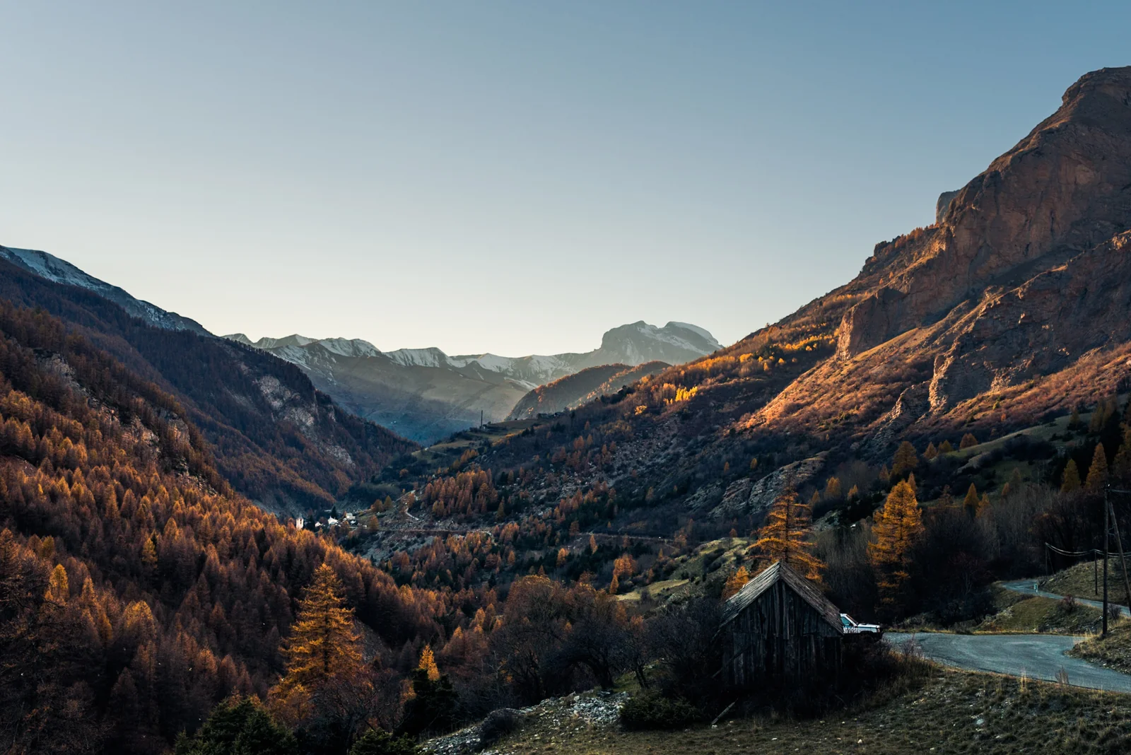 Mountain valley and winding road in warm evening light