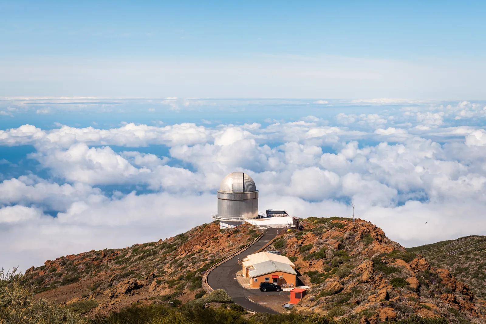 Observatory dome on a mountain above the clouds