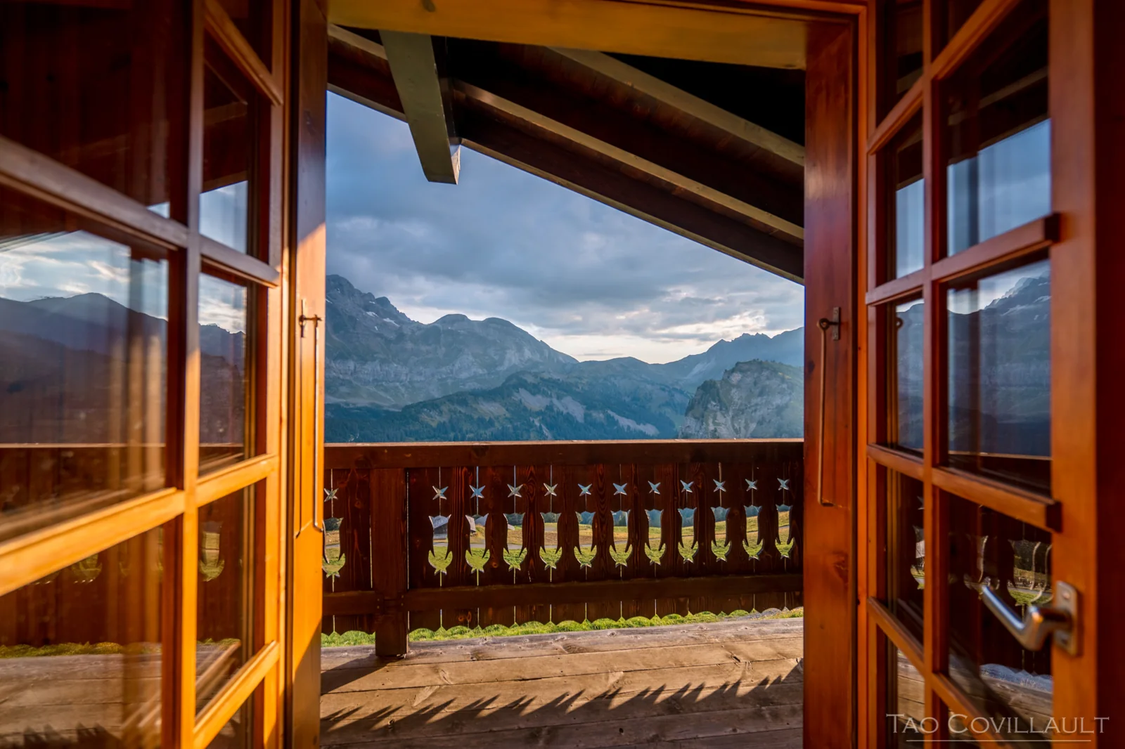 Mountain view through open chalet doors.