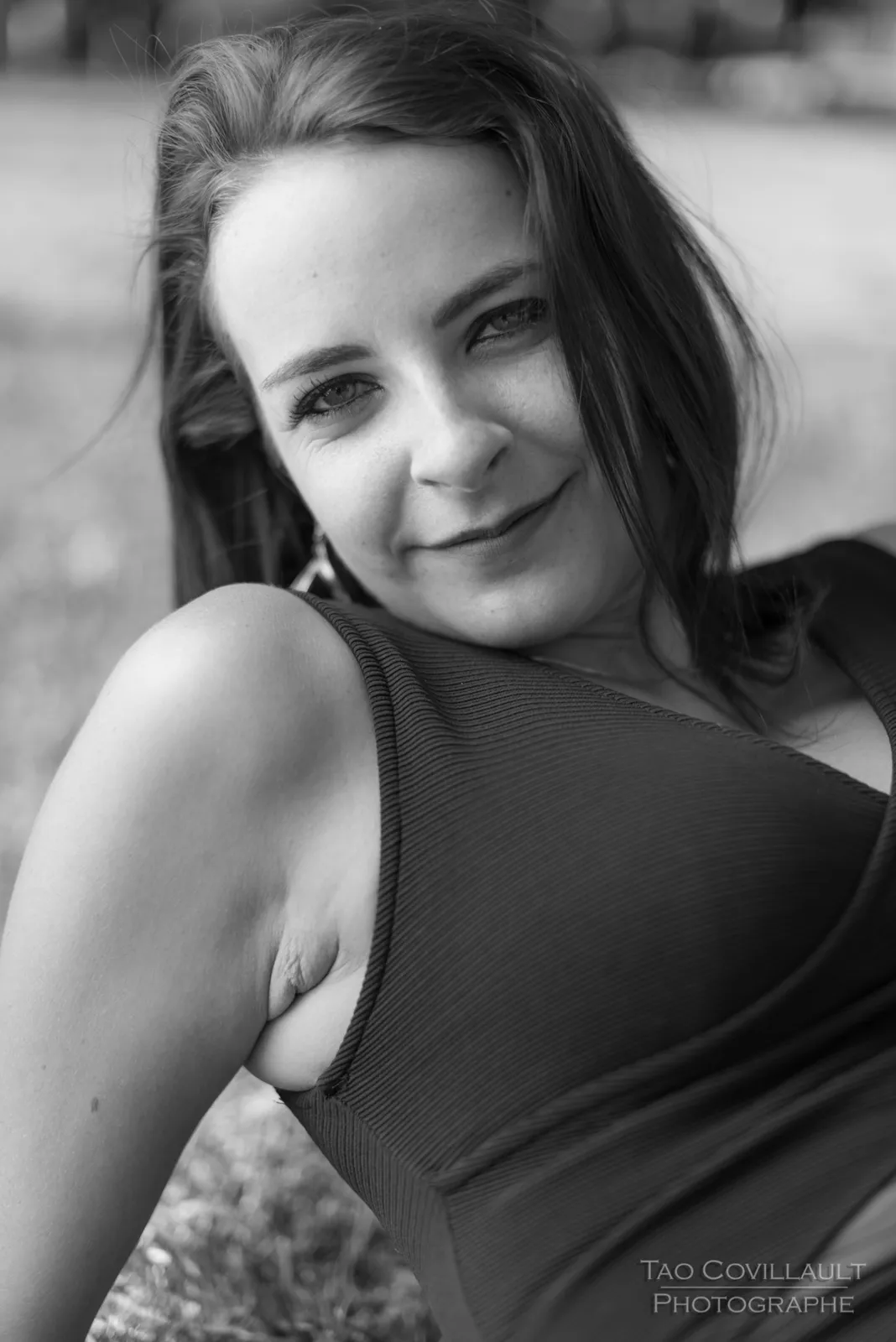 Black-and-white photograph: close-up portrait of a woman in a black dress.