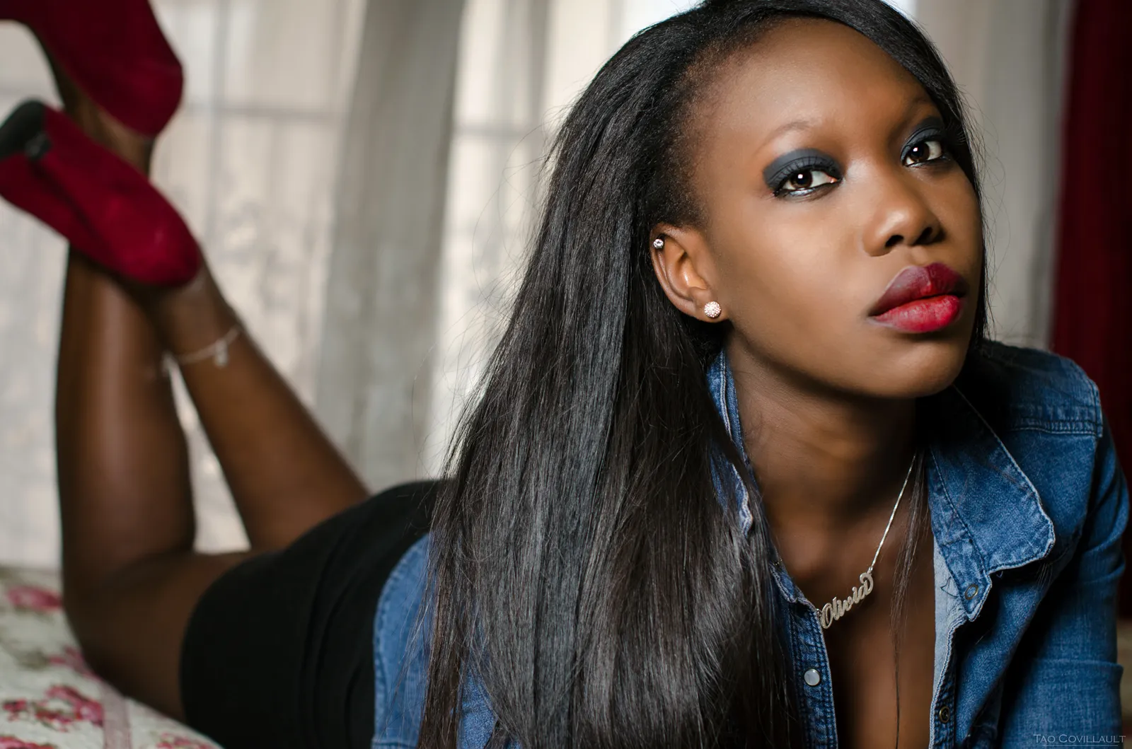 Close-up portrait of a woman wearing a denim shirt.