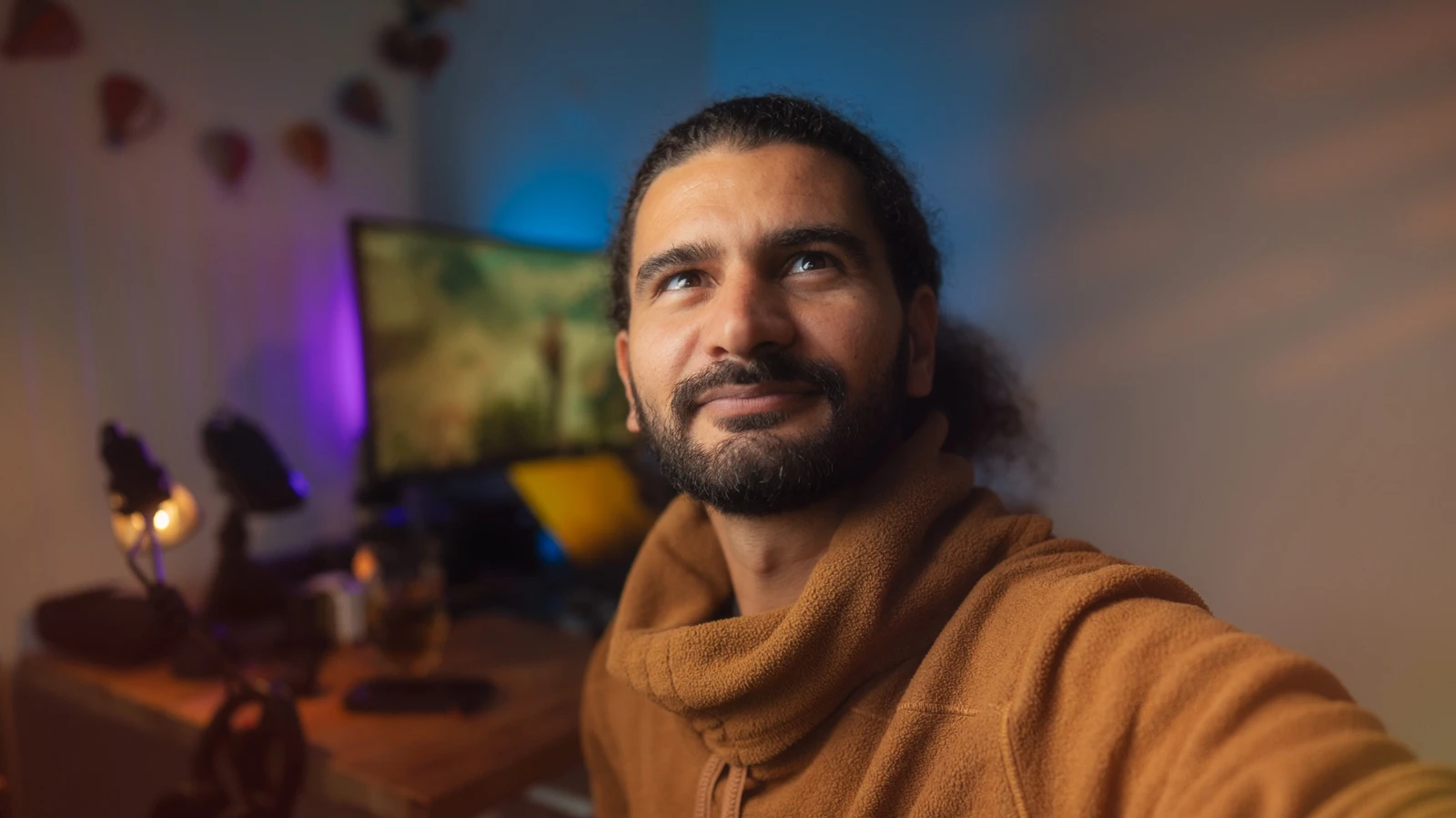 Tao Covillault in a warm brown fleece, photographed in his creative workspace
